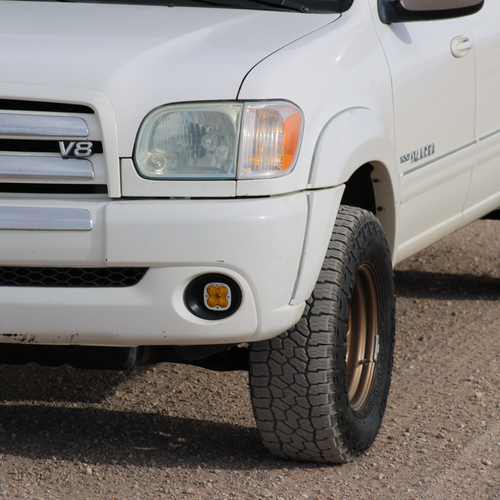 Amber Baja Designs Squadron fog light on the front end of a white 1st Gen Toyota Tundra